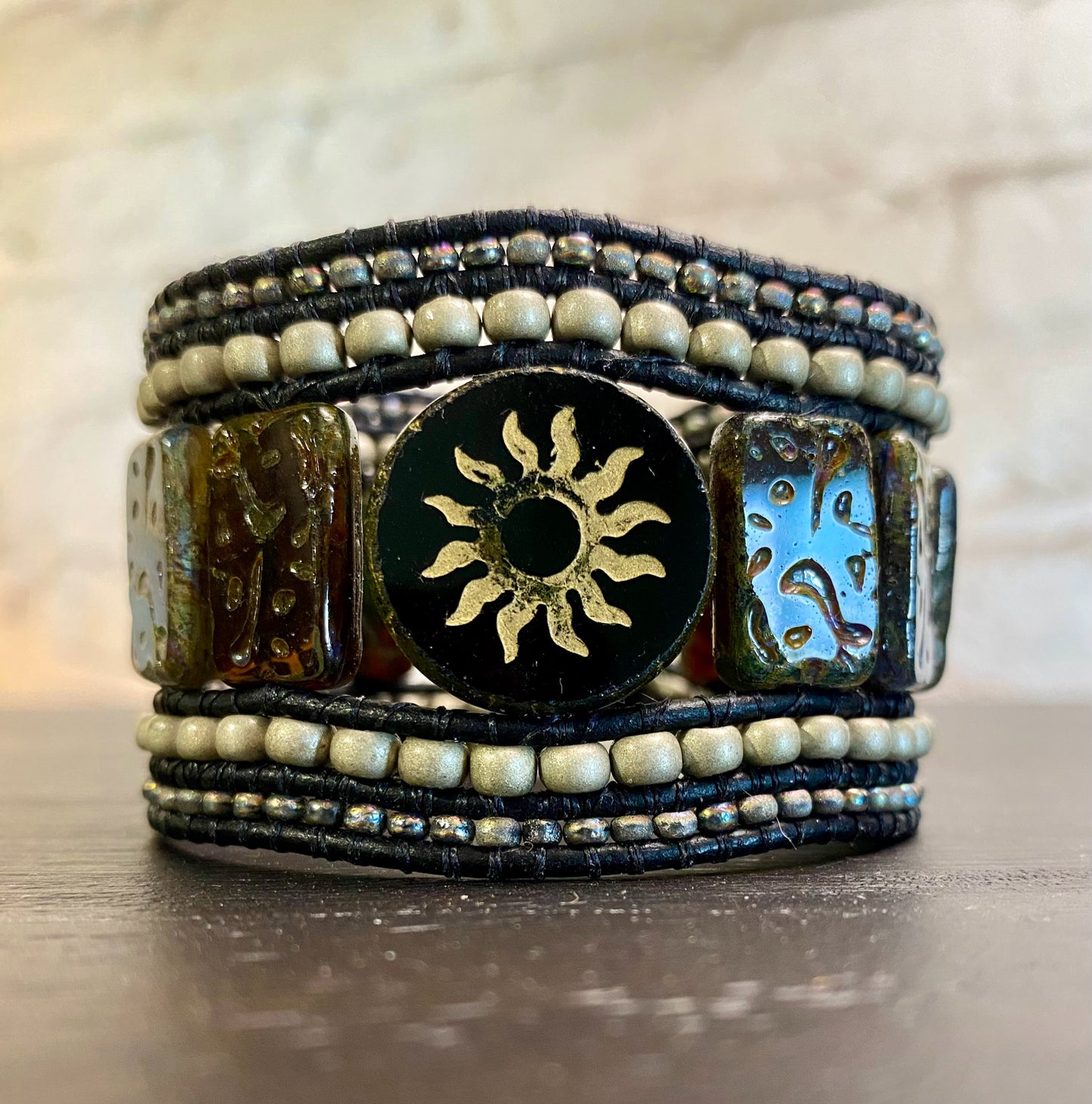 Cuff bracelet, black sun, 5 beaded rows, black