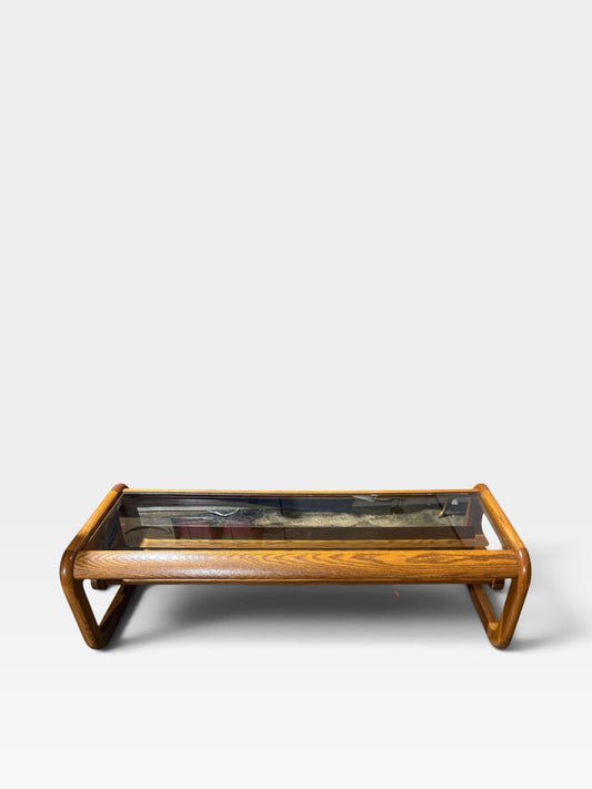 VTG 1970s Modernist coffee table w/sled base, oak/smoked beveled glass